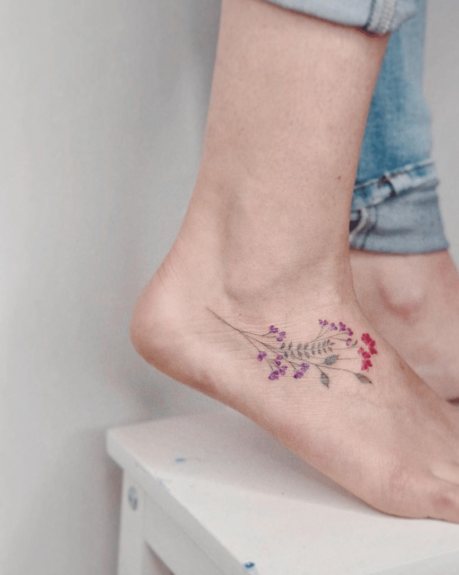 Female feet with tattoo on carpet Stock Photo - Alamy