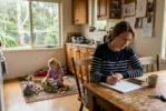 Single mum working out whether she can afford to be a stay-at-home mum at her kitchen table