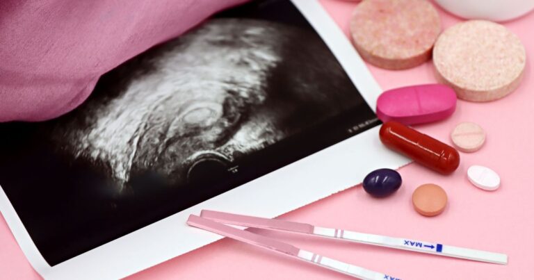 Sperm - Beanstalk Mums Ultrasound image on a tablet surrounded by pink pills and two pregnancy test sticks on a pink surface?